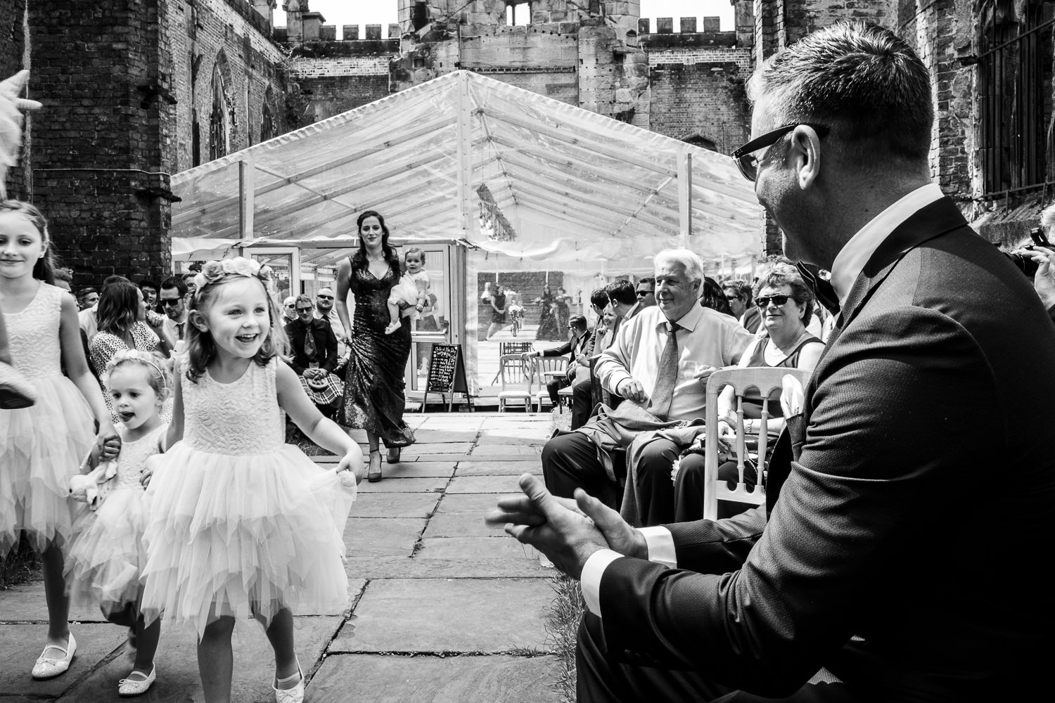 Flower girls arrive during St Luke's Bombed Out Church wedding