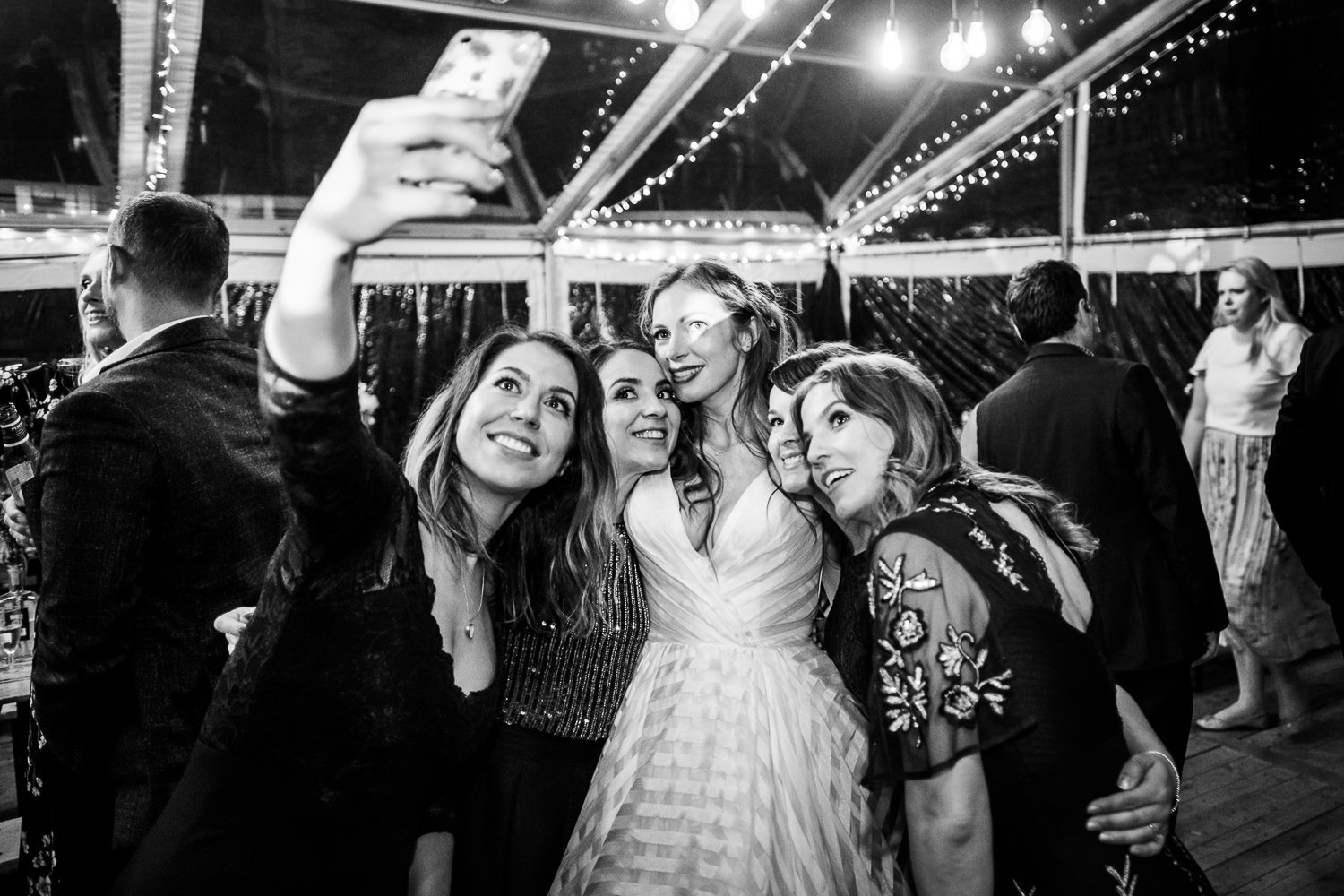 Bride and bridesmaids take a selfie at St Luke's Bombed Out Church wedding