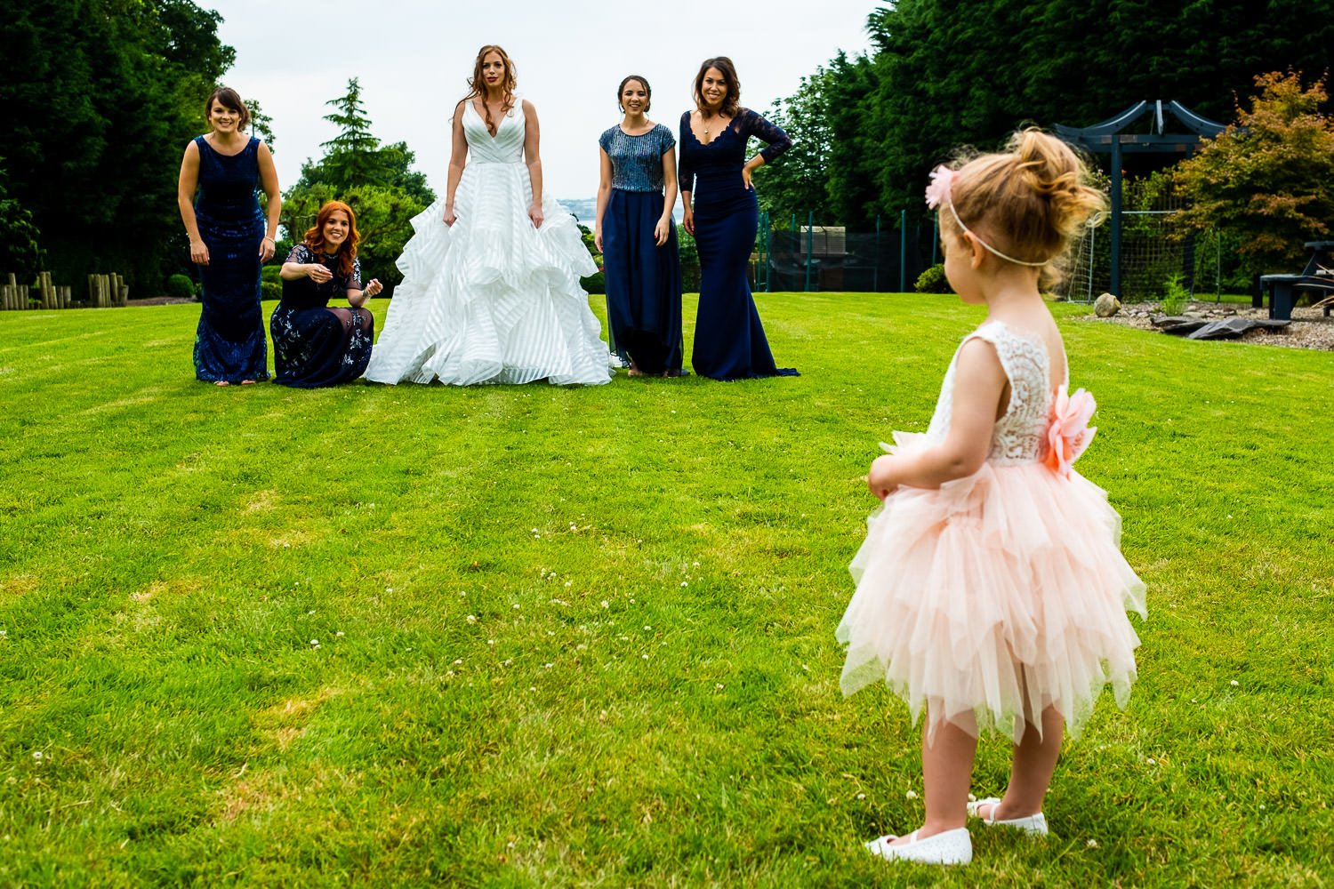 Bridesmaids and flower girl before St Luke's Bombed Out Church wedding photography