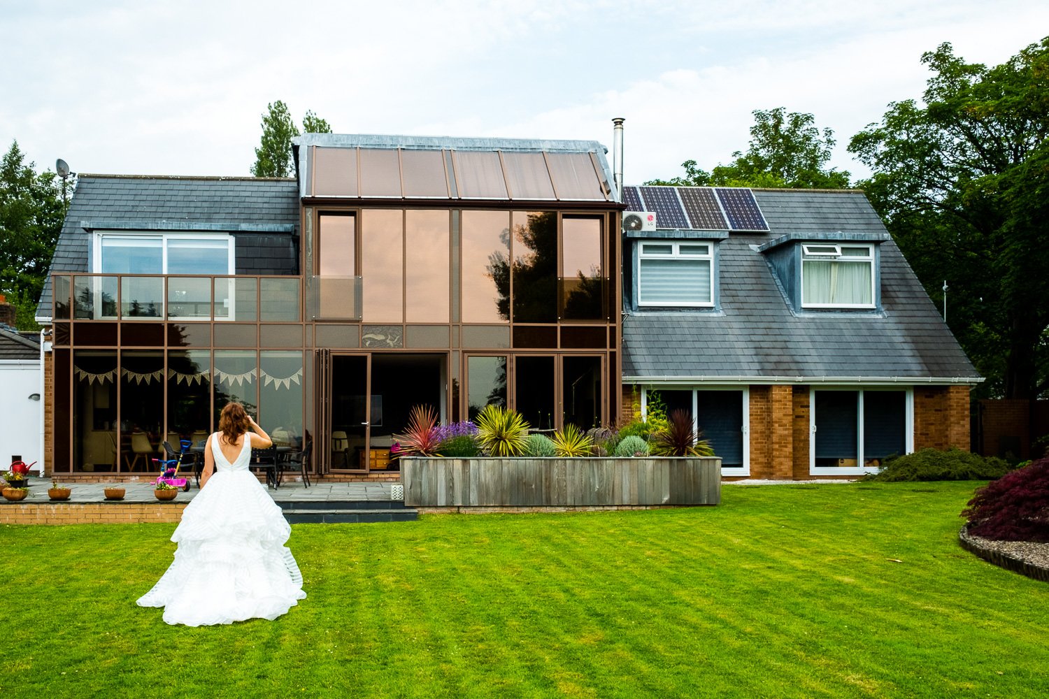 Bride in the garden before St Luke's Bombed Out Church wedding