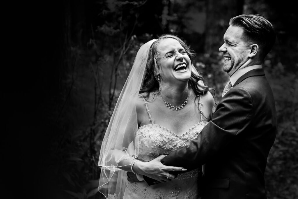 Bride and groom laughing at their Deanwater Hotel wedding in Bramhall, Cheshire