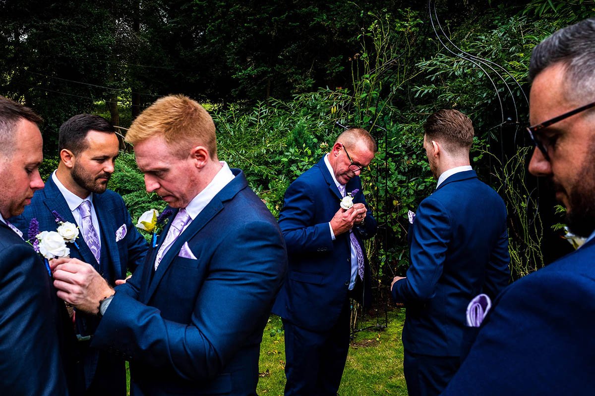 Best man and ushers put the finishing touches to their suits before a Deansgate wedding breakfast in Bramhall, Cheshire