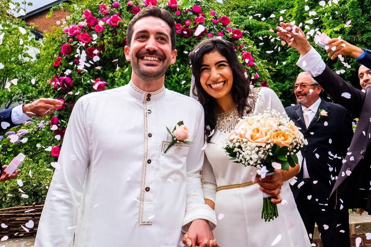 Guests throw confetti at the bride and groom following a Knutsford wedding in Cheshire