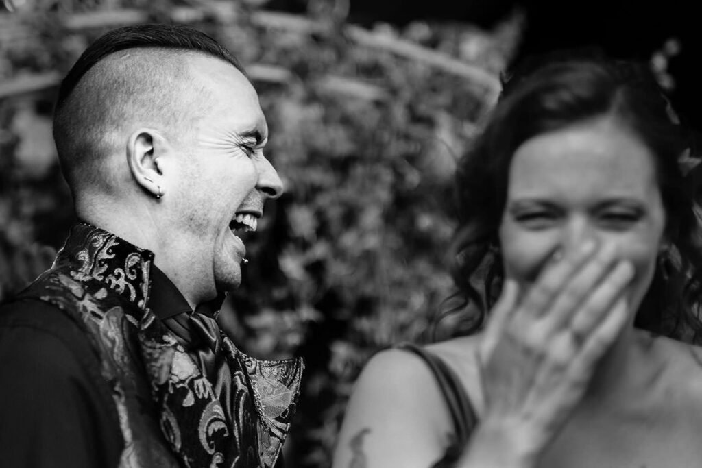 Bride and groom laugh after their Nunsmere Hall wedding ceremony