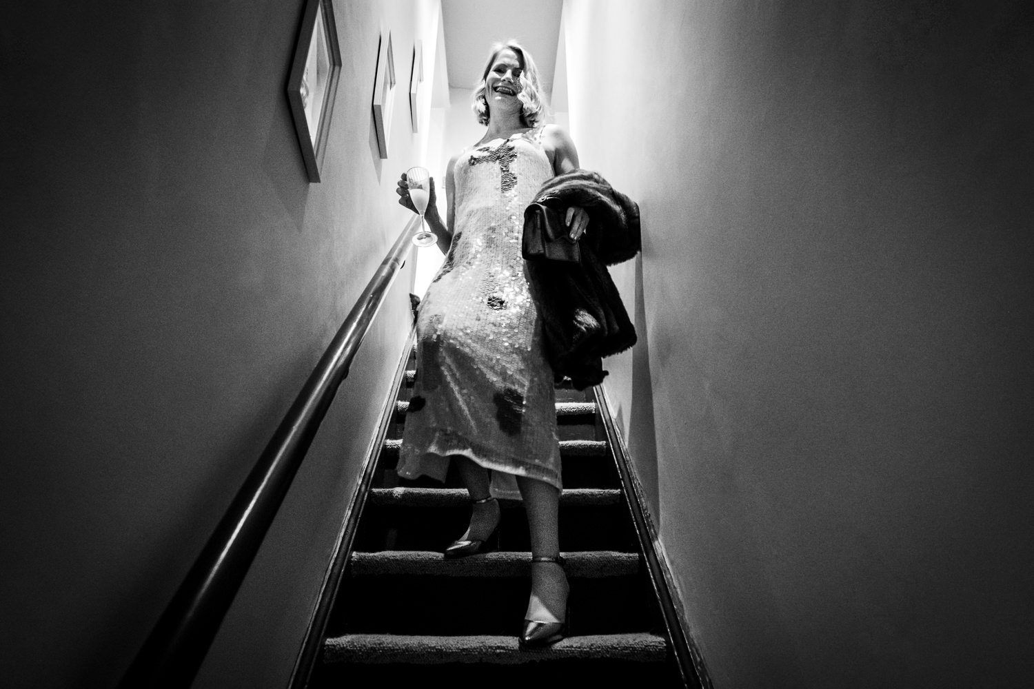 Bride comes down the stairs in her wedding dress