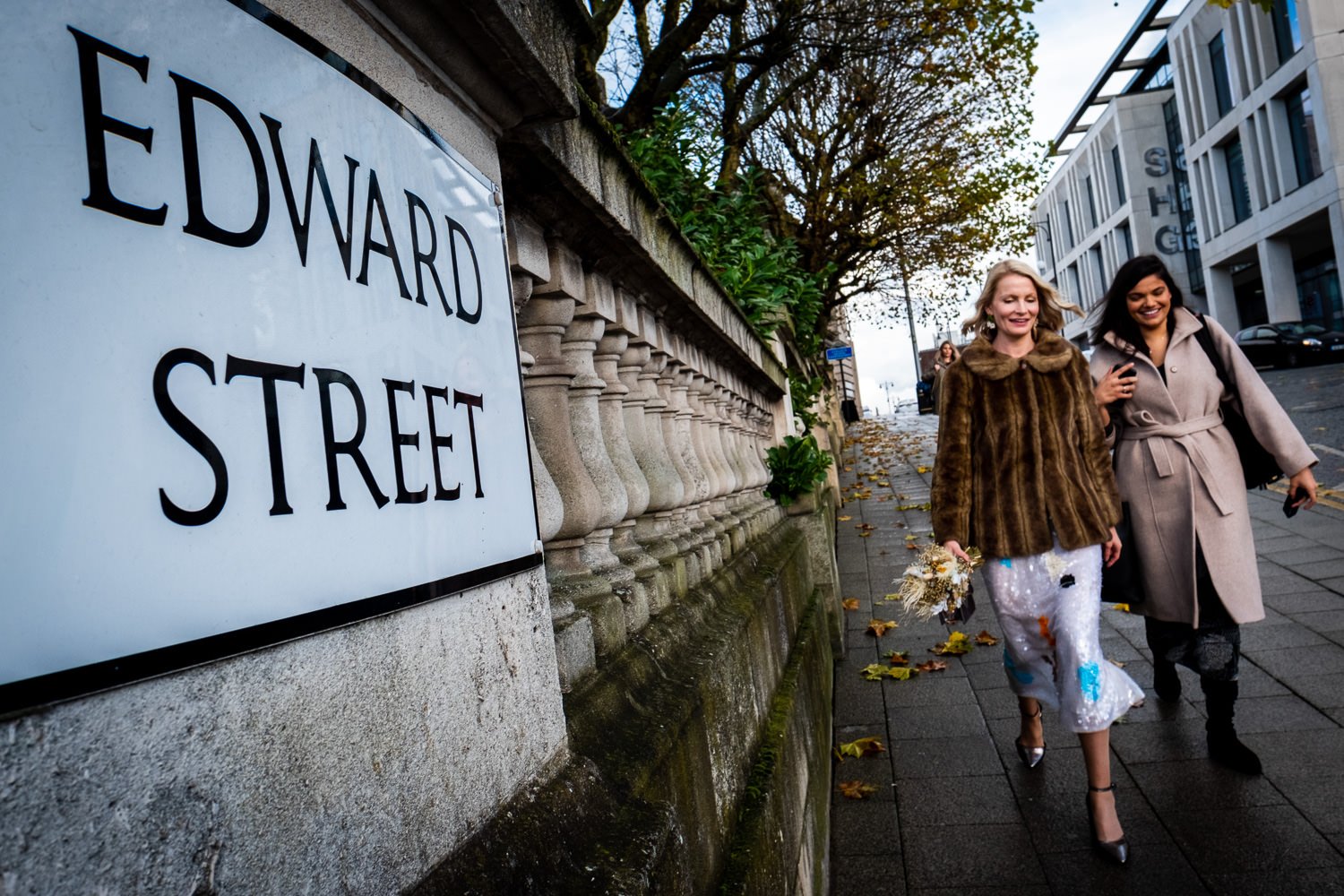 Bride and sister walk towards Stockport Town Hall