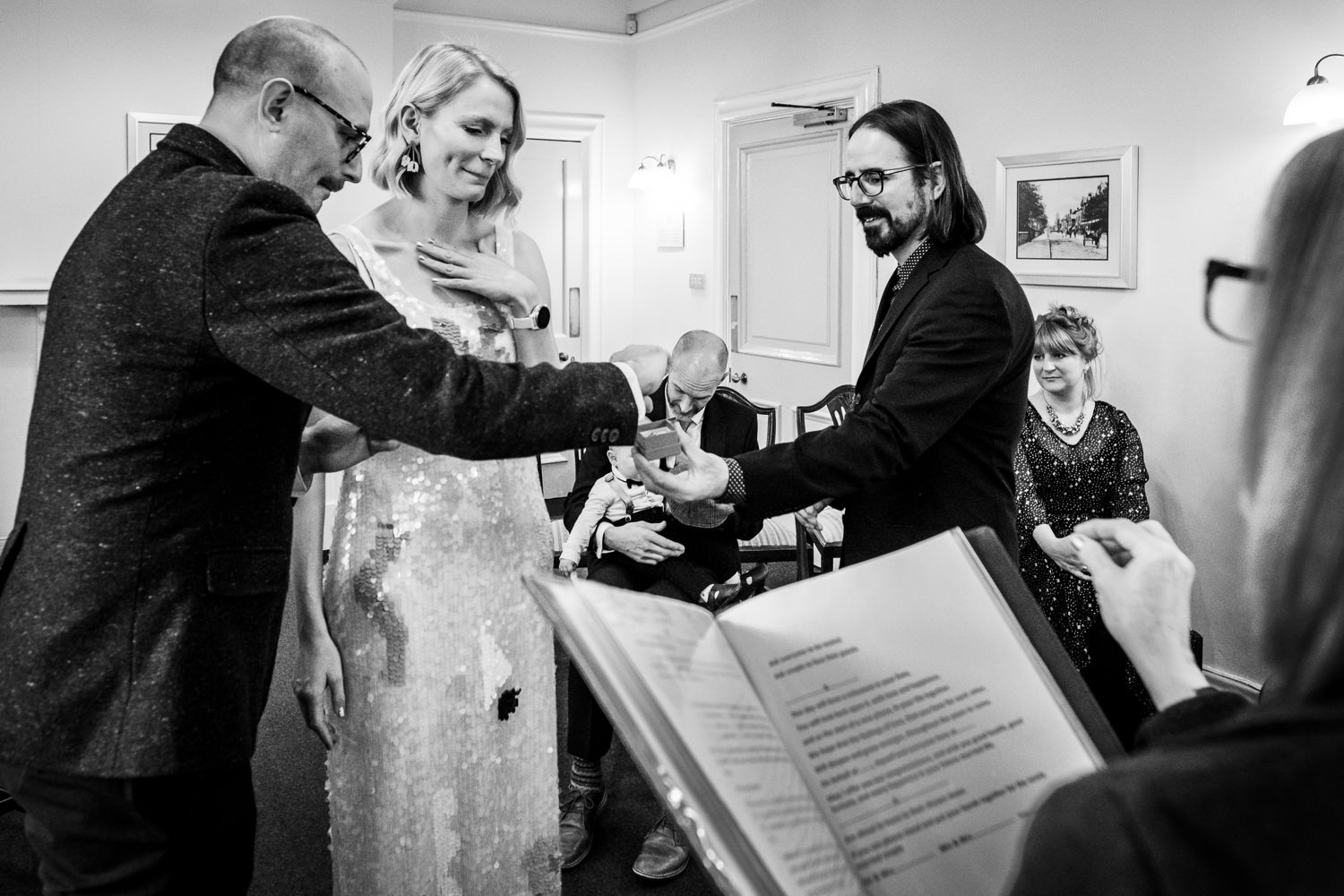 Groom takes the ring as his bride watches on