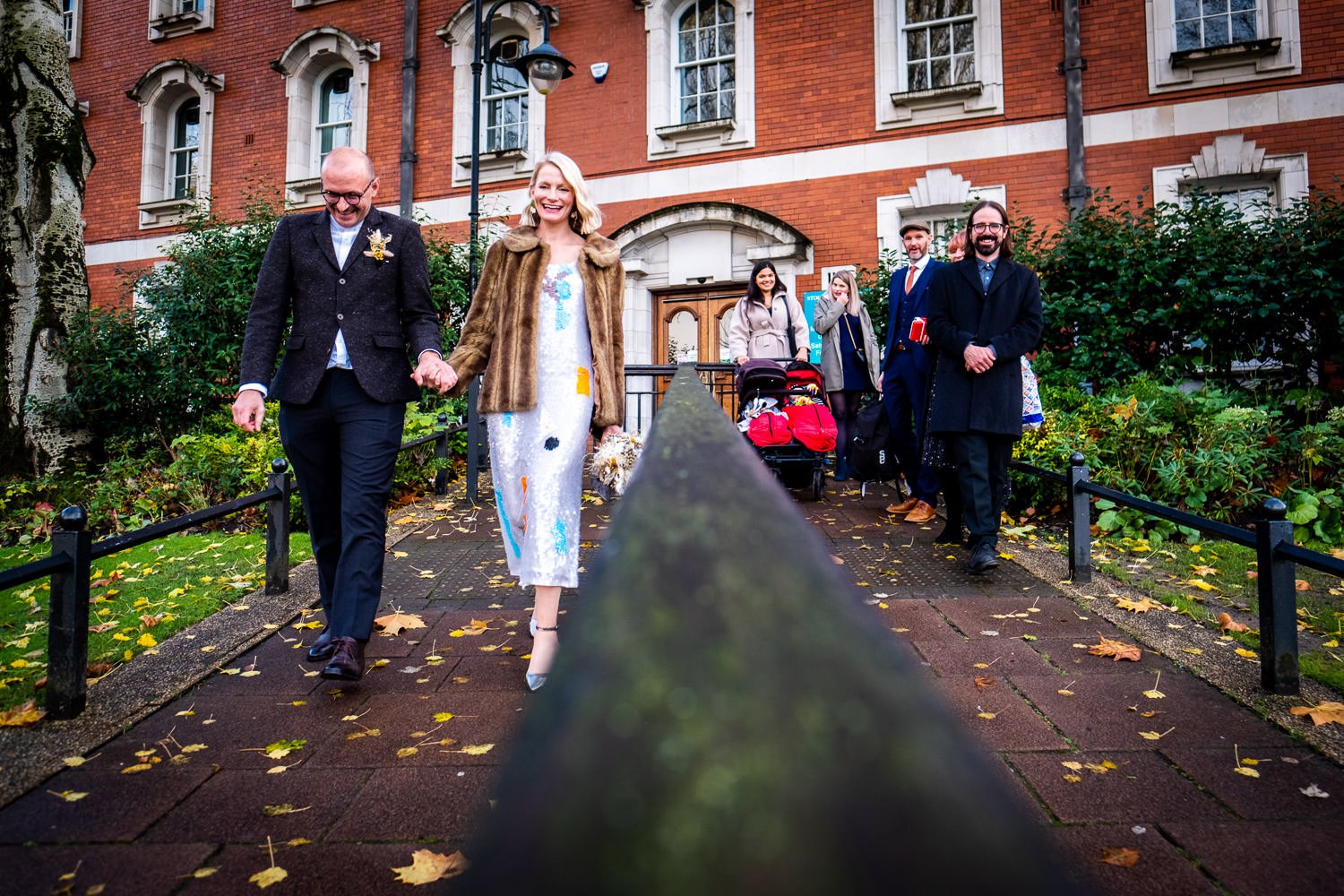 Bride and groom leave Stockport Town Hall after their marriage