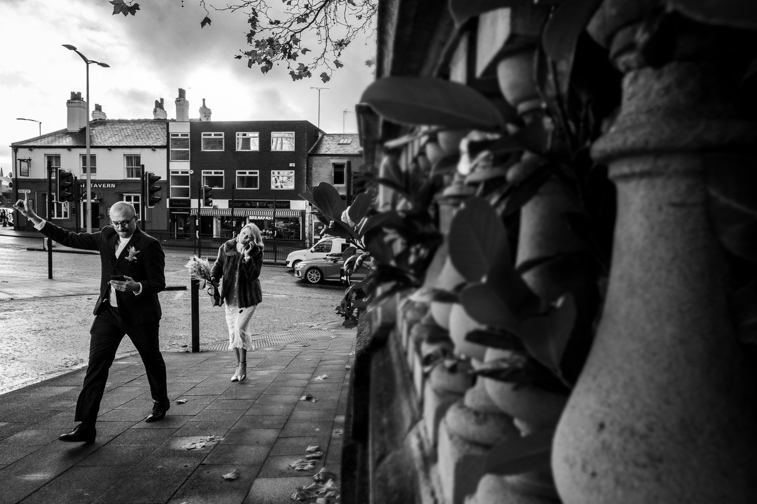 Groom and bride hail a taxi from Stockport Town Hall