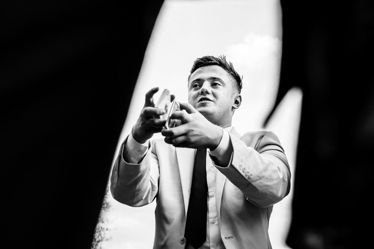 A magician performs tricks at a wedding at Singleton Lodge