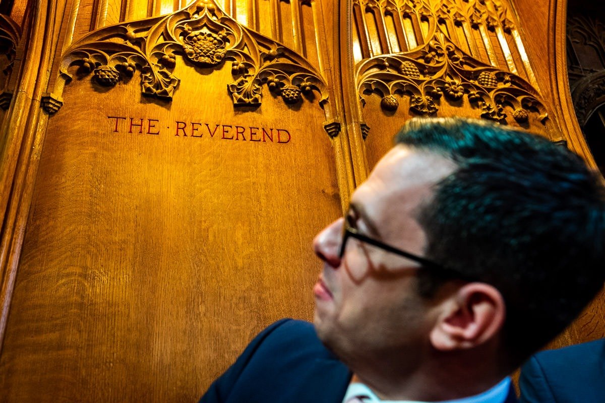 A guest looks at his seat during a Rossall School wedding ceremony