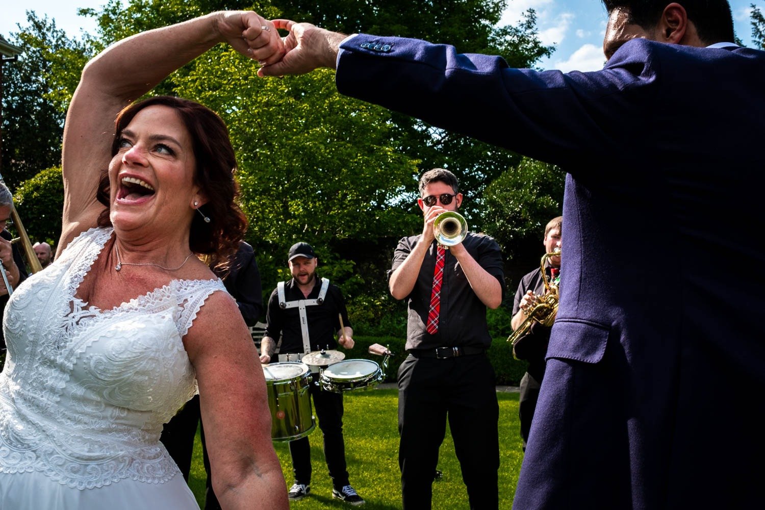 Groom spins bride as they dance to brass band at Grays Court in York