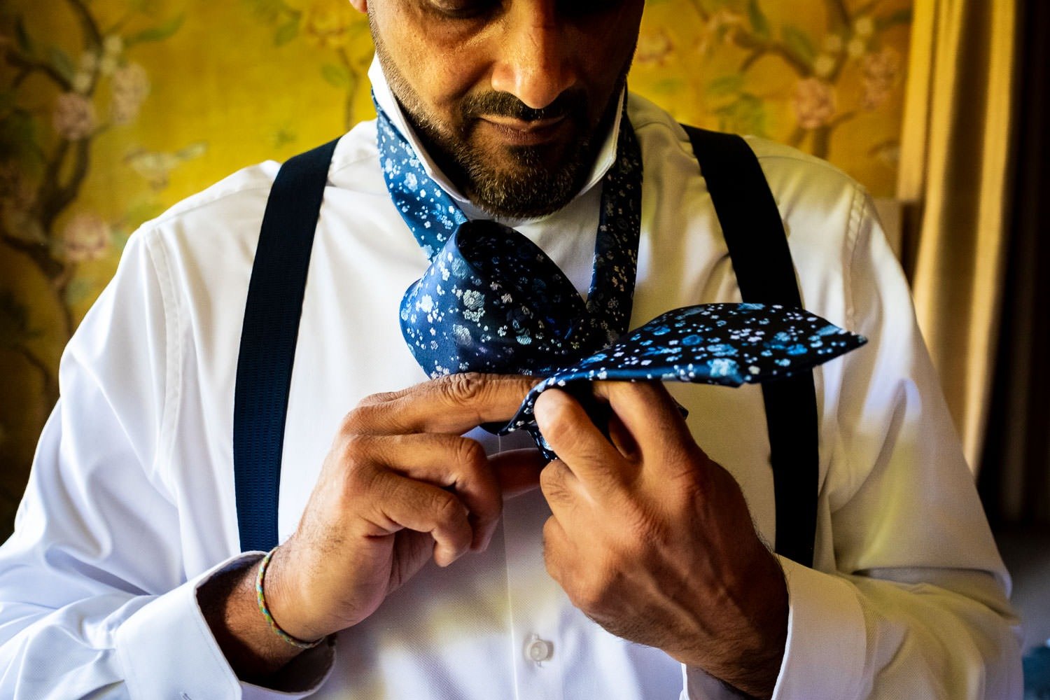 Groom puts tie on before Grays Court wedding in York