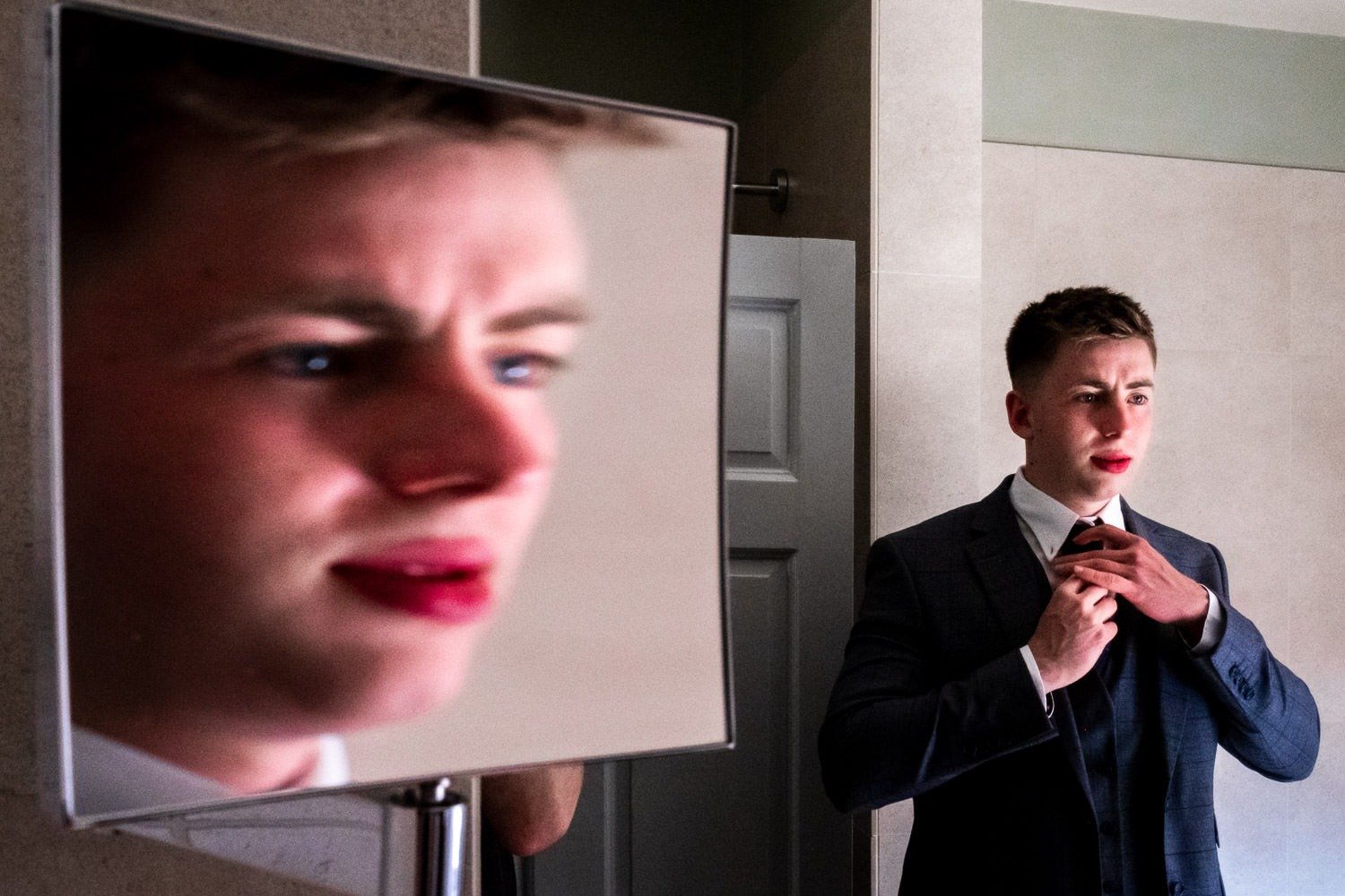 Guest and his reflections in mirrors before Grays COurt wedding