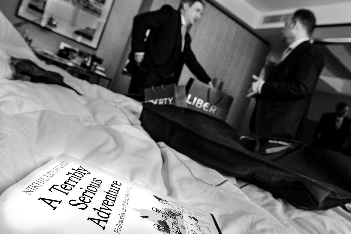 Grooms at Conrad St James hotel with a book entitled 'A Terribly Serious Adventure' in the foreground