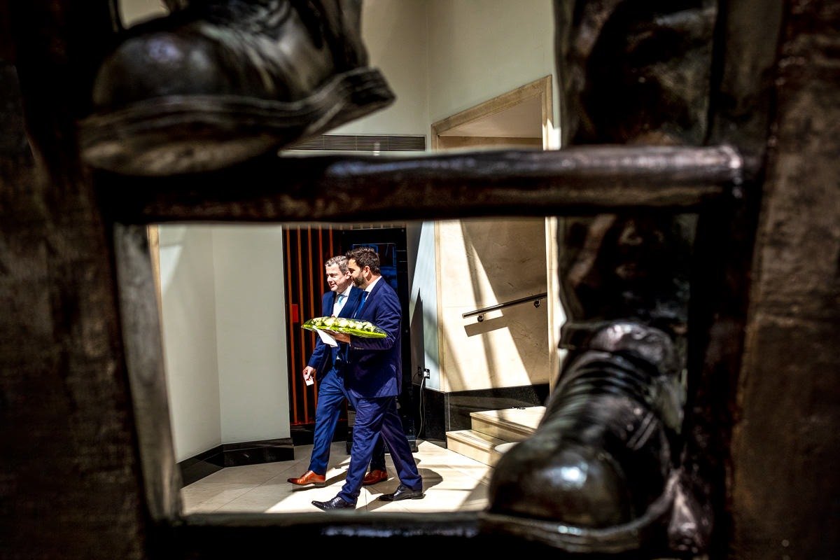 Groom and best man leave Conrad St James hotel