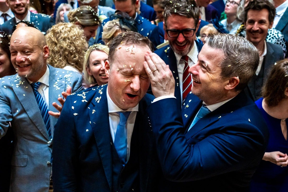 Groom wipes confetti off partner's face at One Great George Street