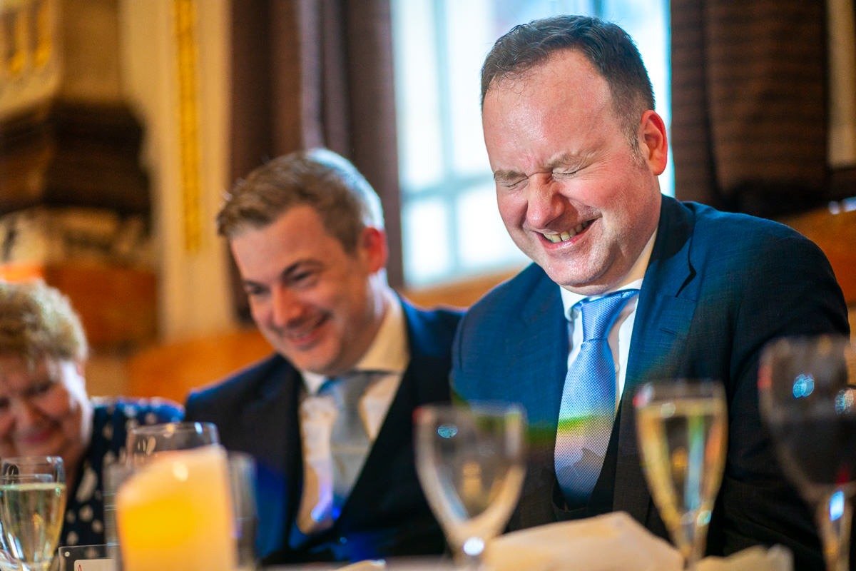 Groom laughs with eyes shut at One Great George Street wedding