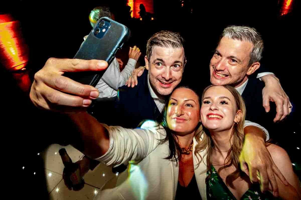 Guests for selfie with groom and brother at One Great George Street wedding