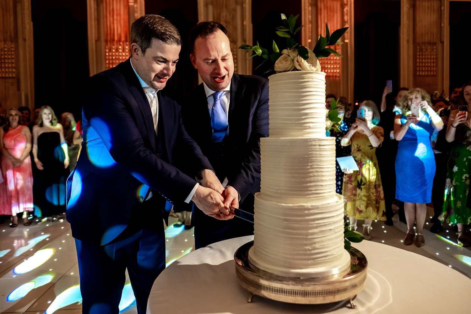 Grooms cut cake at One Great George Street wedding in London