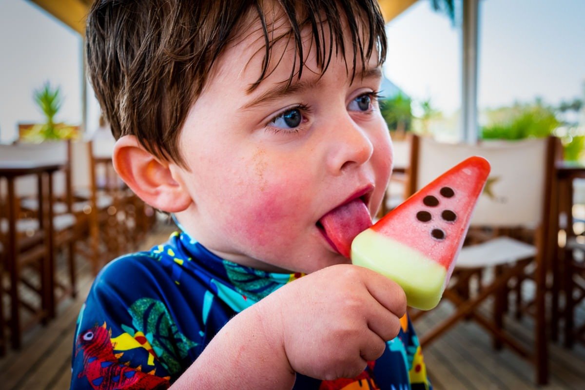 Child eats ice lolly on beach in Vilanova i la Geltrú, near Barcelona