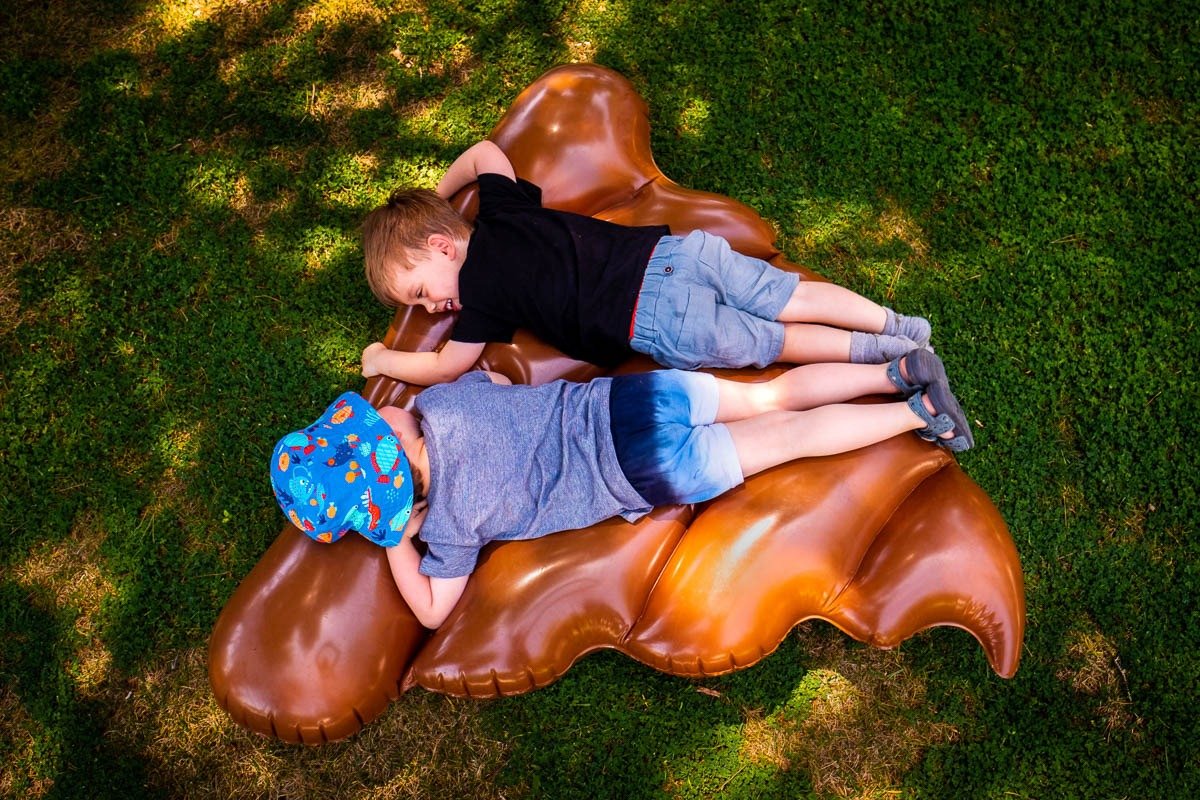 Children play on inflatable poo in Barcelona villa garden