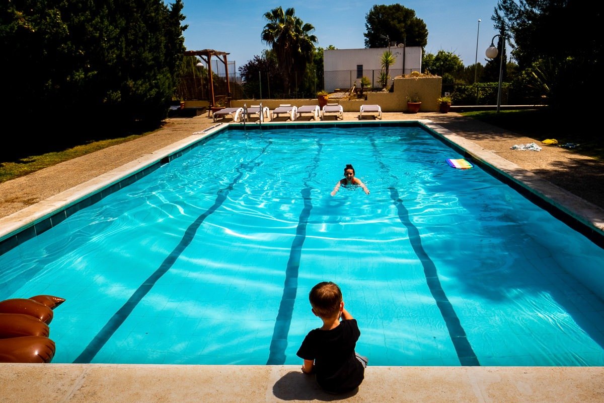 Child watches mother swim in pool in Barcelona villa