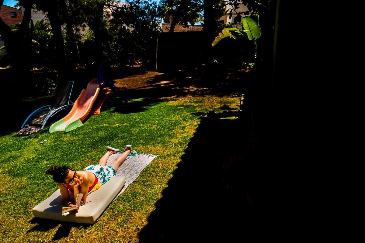 Woman sunbathes in garden of villa in Barcelona