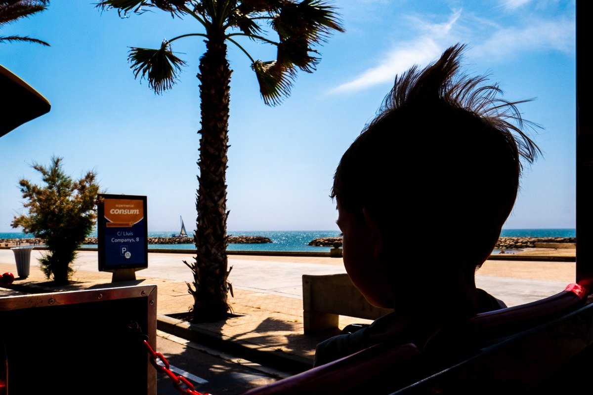 Child's hair silhouetted on train tride in Sitges