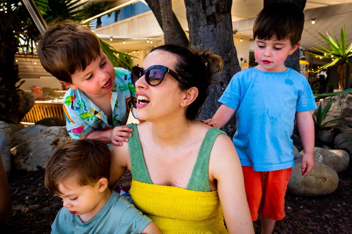 Children climb on adult in Sitges