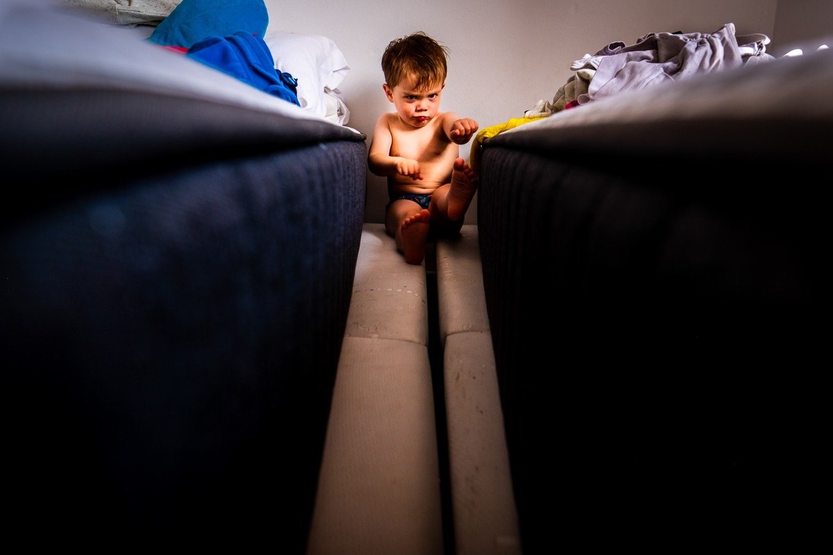 Child plays in bedroom during family holiday