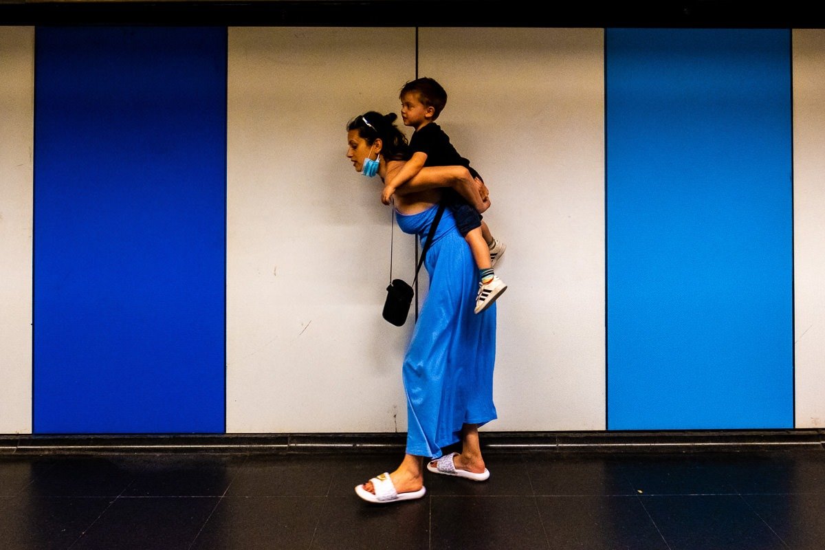 Mother carries son in Barcelona underground