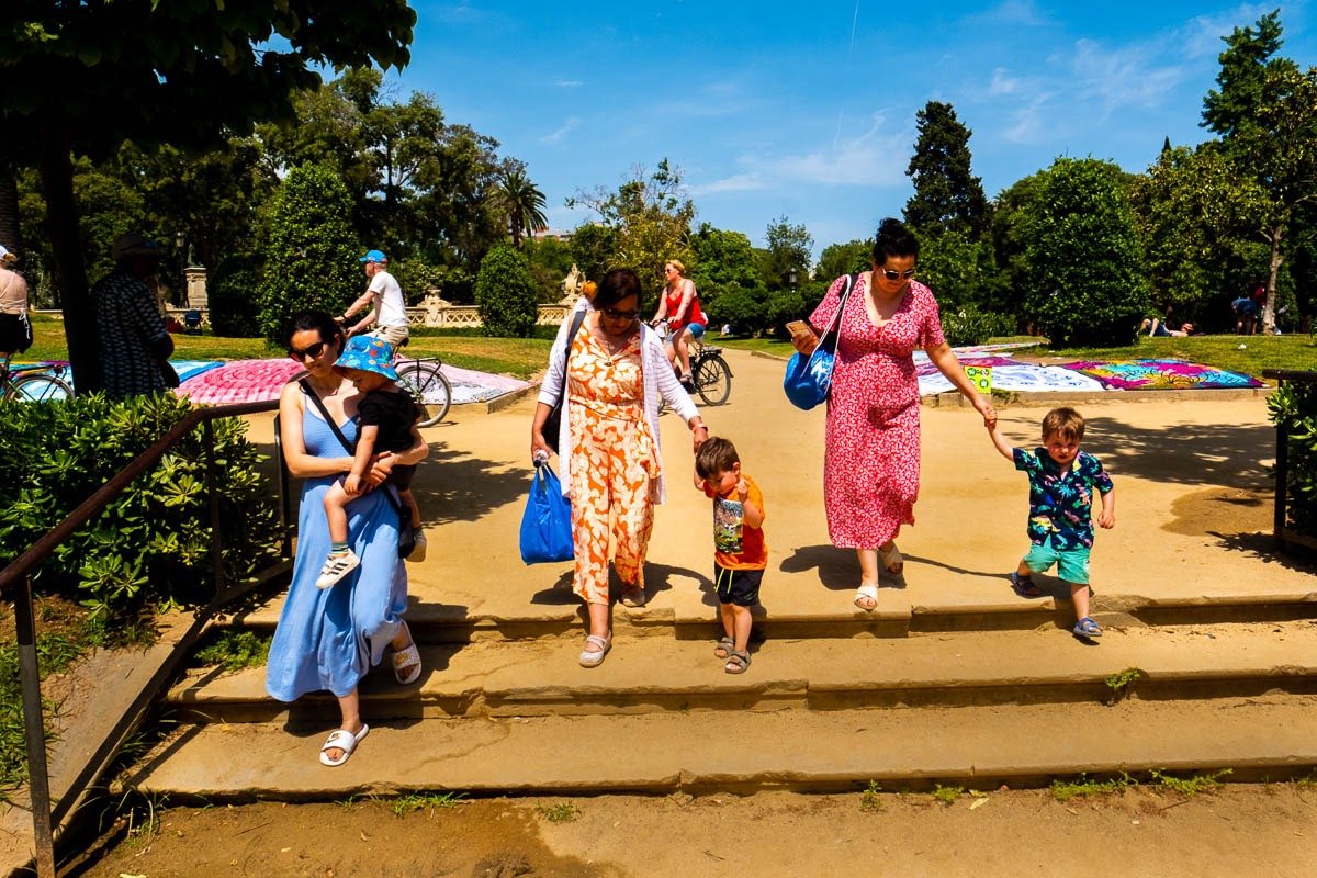 Adults and children walk down steps in Barcelona park