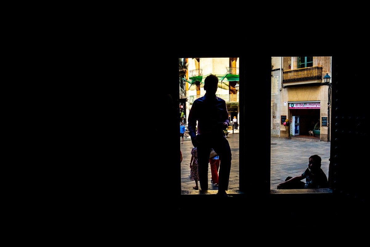 Silhouetted man walks through day into church