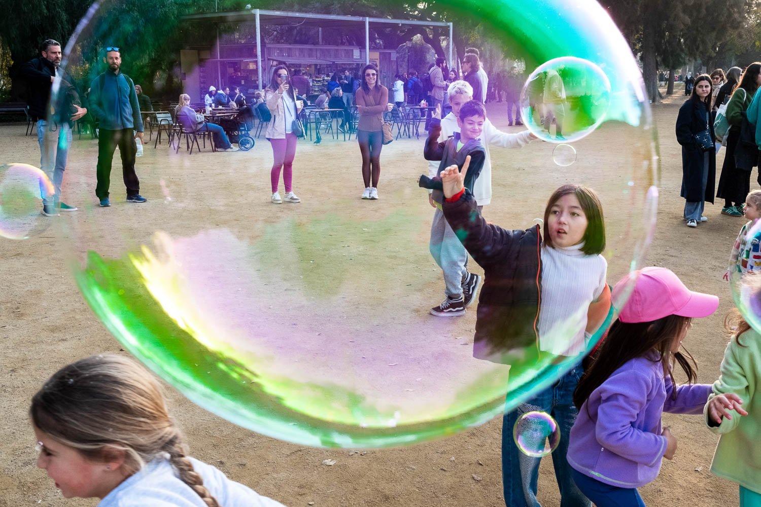 Children play with bubbles in Parc de la Ciutadella in Barcelona