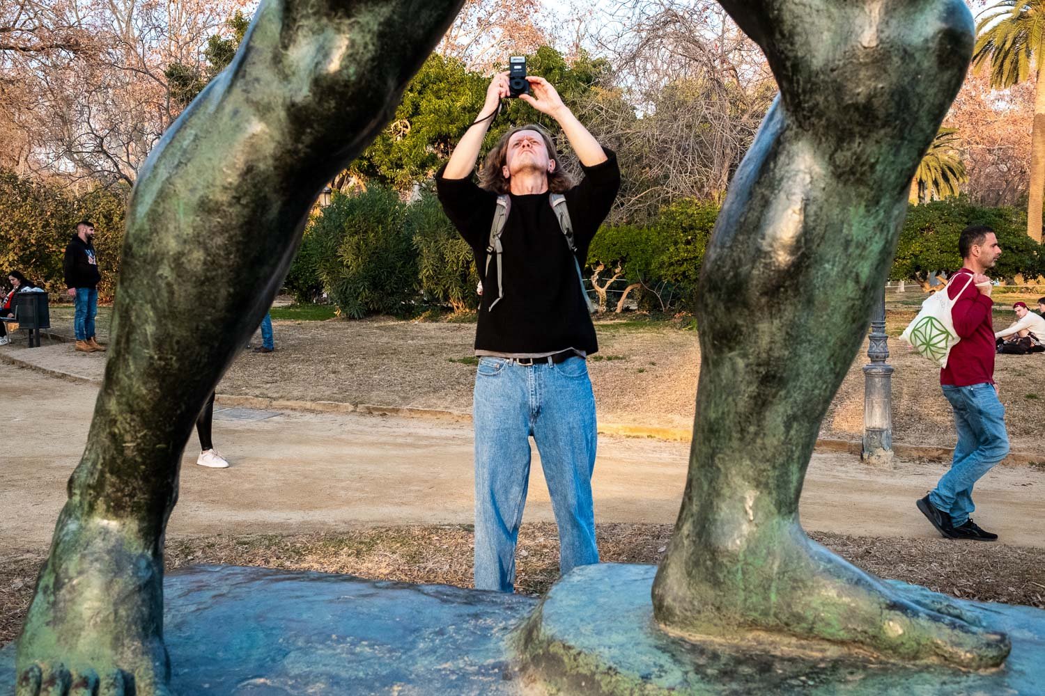 Man takes photo from underneath statue in Barcelona