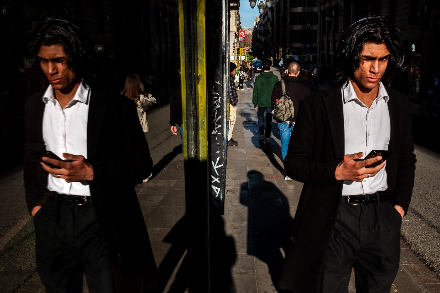 Man reflected in shop window on Barcelona street