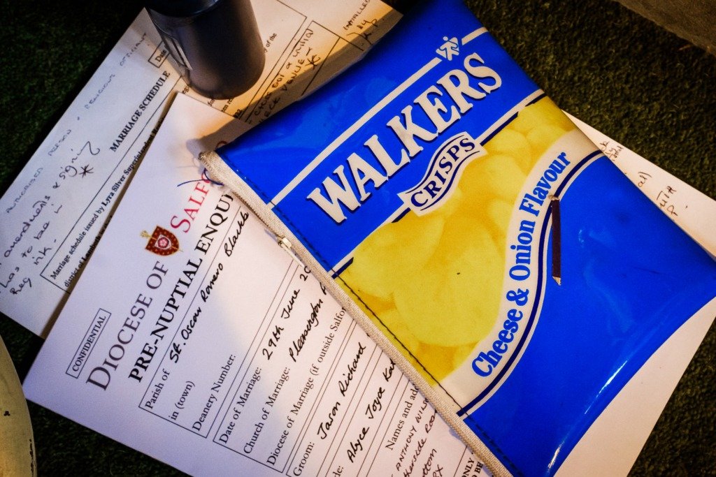 A pencil case in the style of a packet of Walkers crisps during a wedding service at Pleasington Priory in the Ribble Valley