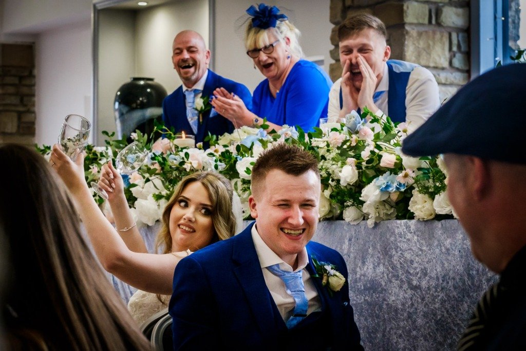 Bride and groom and wedding guests laugh during a 'Mr and Mrs' game at Mytton Fold Hotel