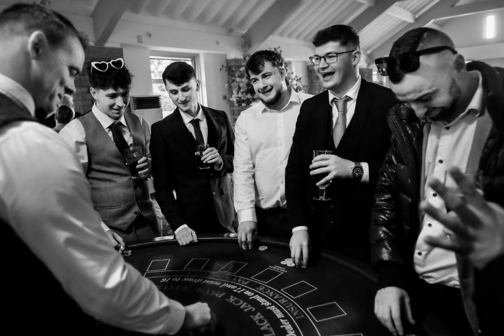 Guests play cards at a pop-up casino during a Mytton Fold Hotel wedding in the Ribble Valley