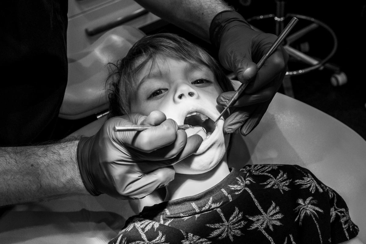 Manchester family photographer 1 A dentist inspects a child's teeth